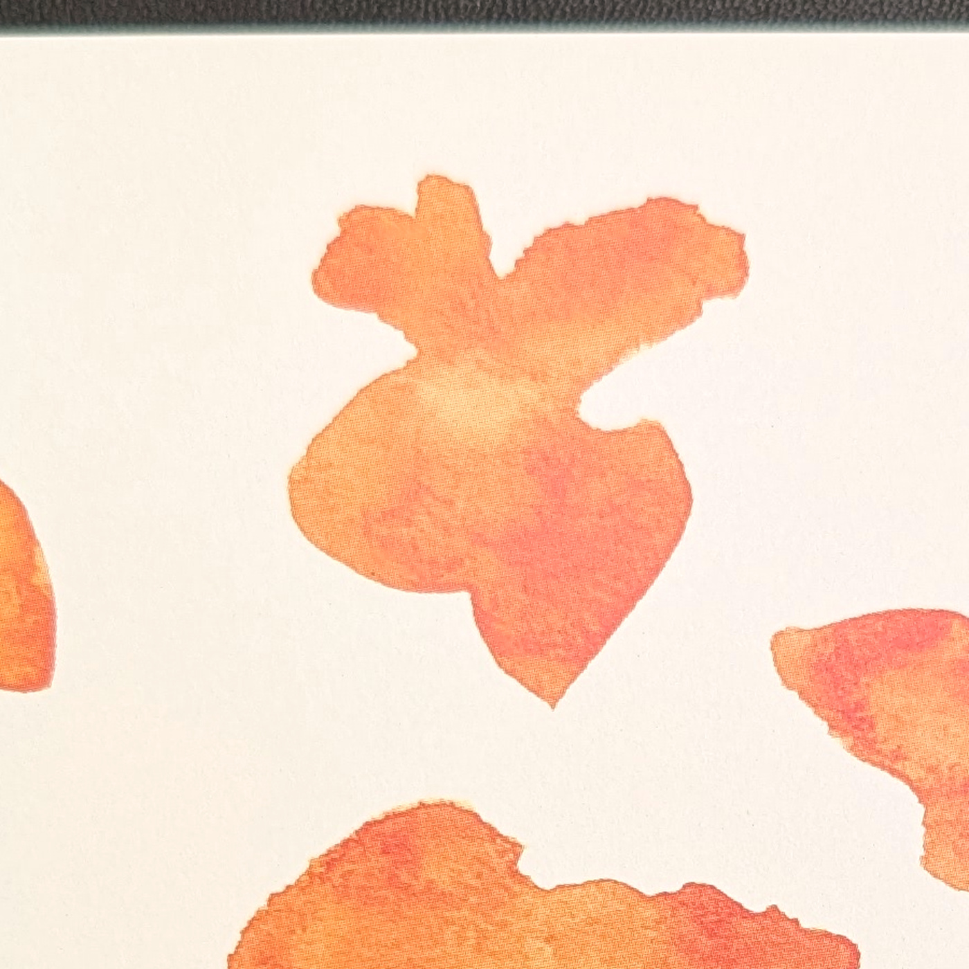 A close view of one untouched orange watercolor shape.