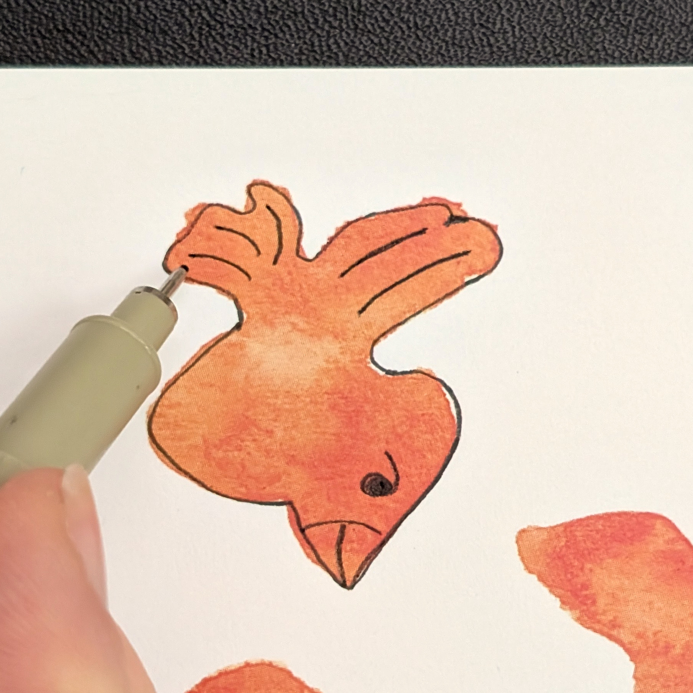 Fineliner details being added to the orange shape.