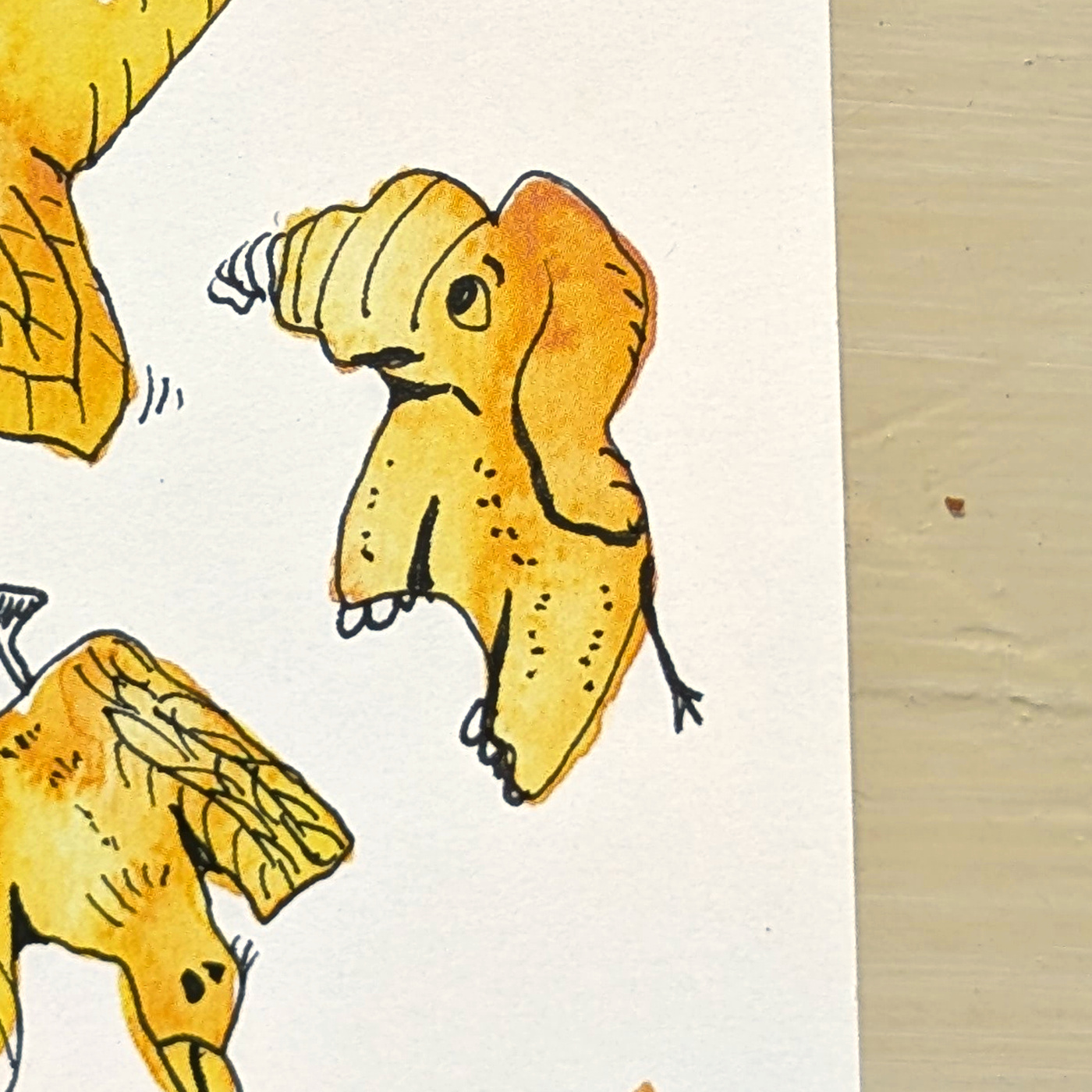 The yellow watercolor shape with fineliner details added.